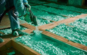 Worker Spraying Polyurethane Foam For Insulating Wooden Frame House.